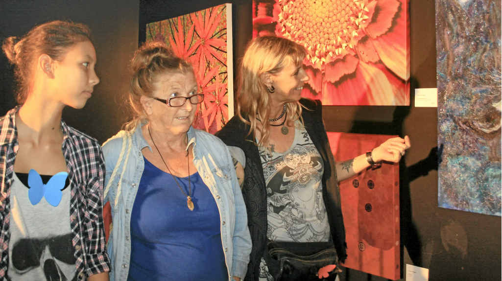 LOVING THE ART: Kayona Mudita and her mother Patrizia, visitors from overseas, enjoy some of the paintings in the Community Centre, with Pippy Wardell of Byron Bay (centre). LOVING THE ART: Kayona Mudita and her mother Patrizia, visitors from overseas, enjoy some of the paintings in the Community Centre, with Pippy Wardell of Byron Bay (centre).